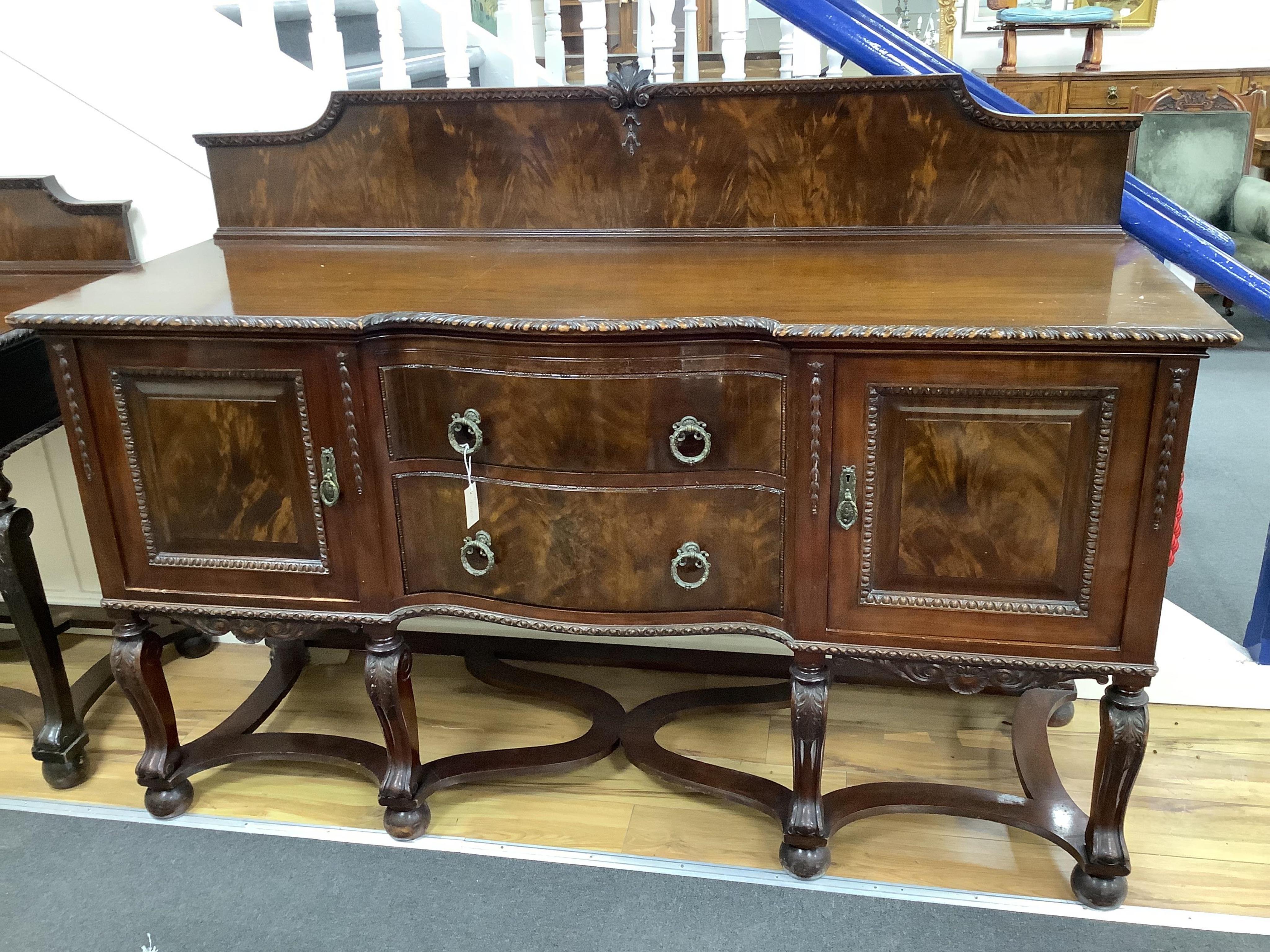 A Chippendale Revival mahogany dining suite comprising an extending dining table, width 300cm extended, depth 122cm, height 74cm, ten chairs (two with arms), a serpentine sideboard and a serving table. Condition - fair t